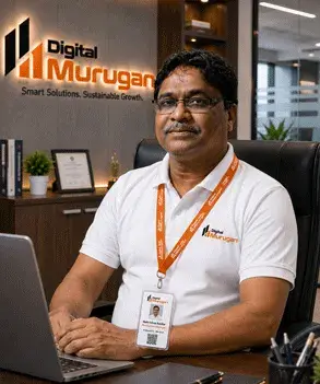 Balkrishna Bavkar, Production Manager at Digital Murugan, seated in a modern corporate office wearing the official Digital Murugan polo shirt and company ID card.